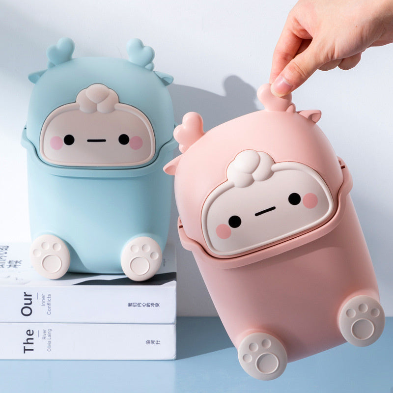Two cute, cartoon-style animal-shaped containers in pink and blue on a light gray background.